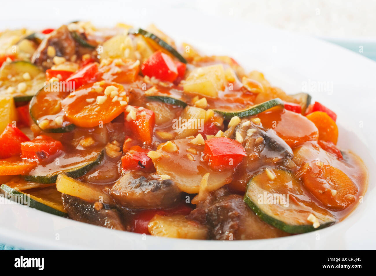A wonderful combination of vegetables in sweet and sour sauce, garnished with chopped nuts. Stock Photo
