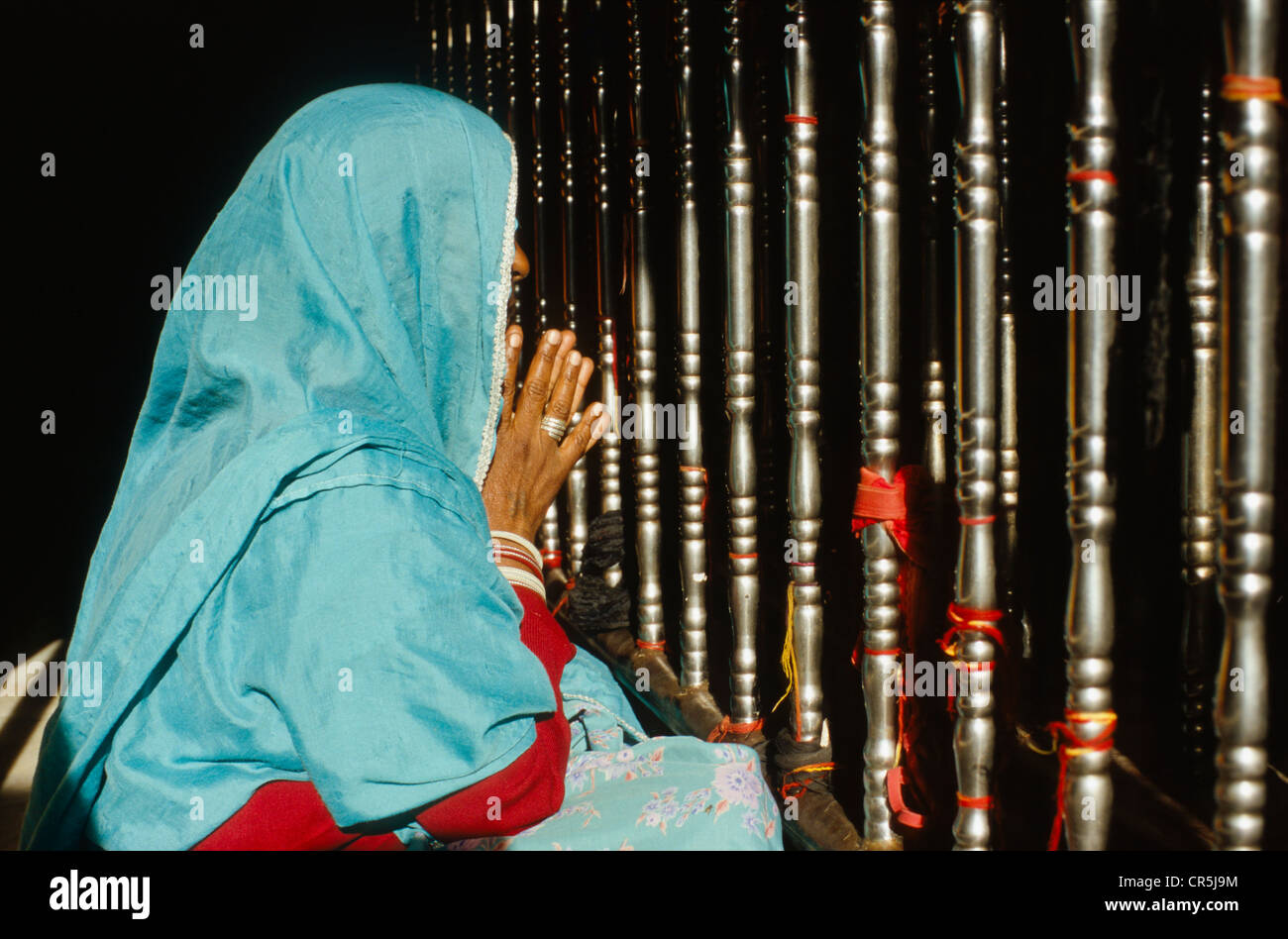 Woman praying at a temple in the holy place Baba Ram Dev, Jaisalmer, Rajasthan, India, Asia Stock Photo