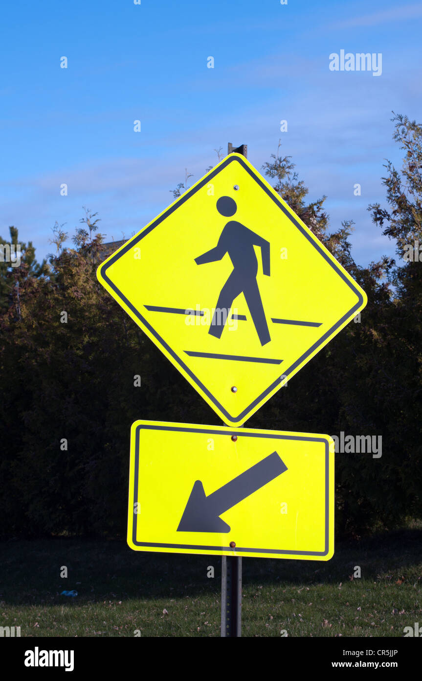 Human crossing path street yellow sign Vermont USA Stock Photo