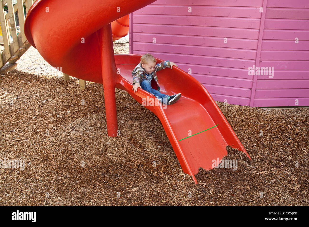 Red children's slide at Woodlands Family Theme Park, Totnes, Devon , England, United Kingdom. Stock Photo