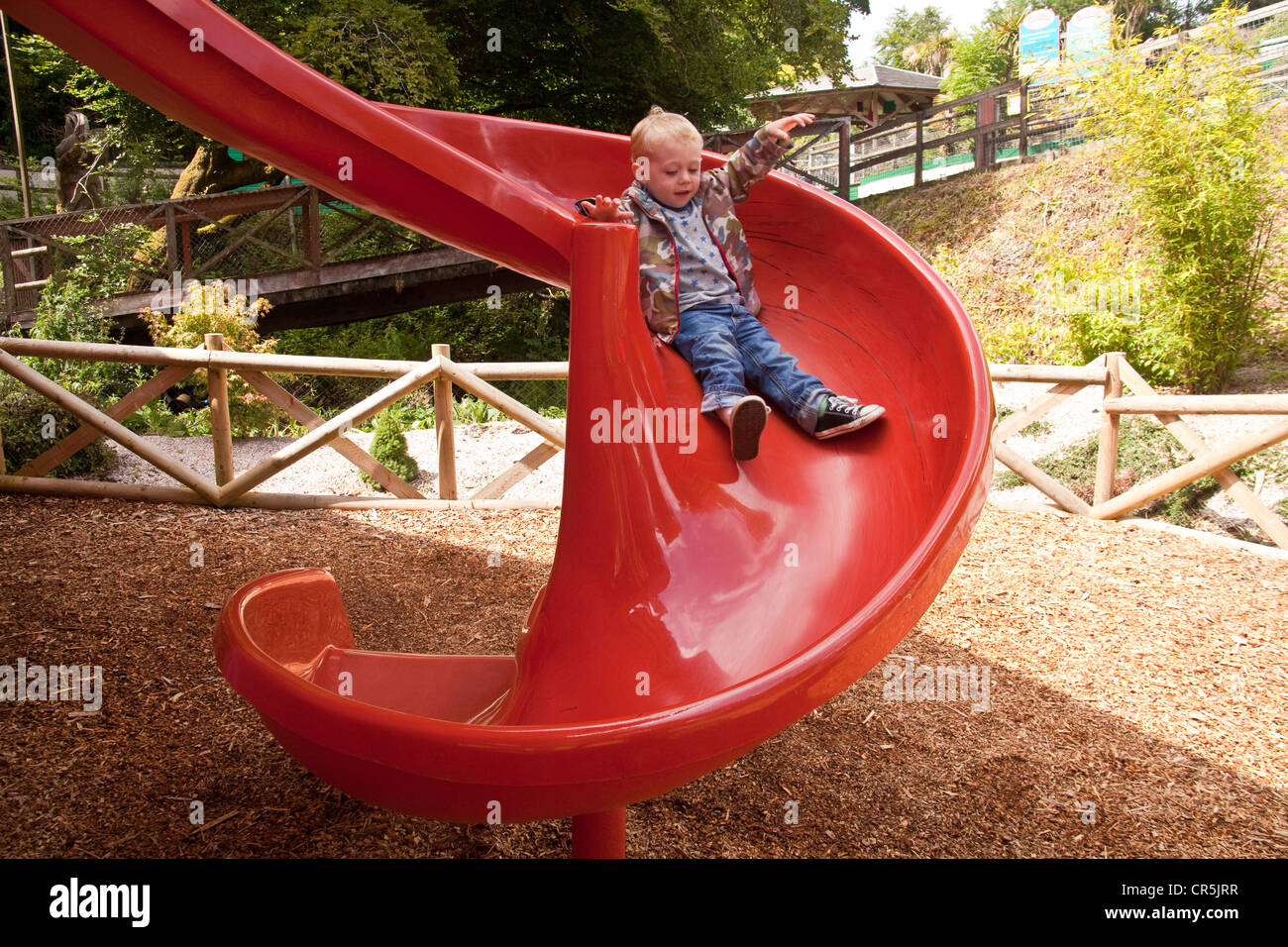 Red children's slide at Woodlands Family Theme Park, Totnes, Devon , England, United Kingdom. Stock Photo