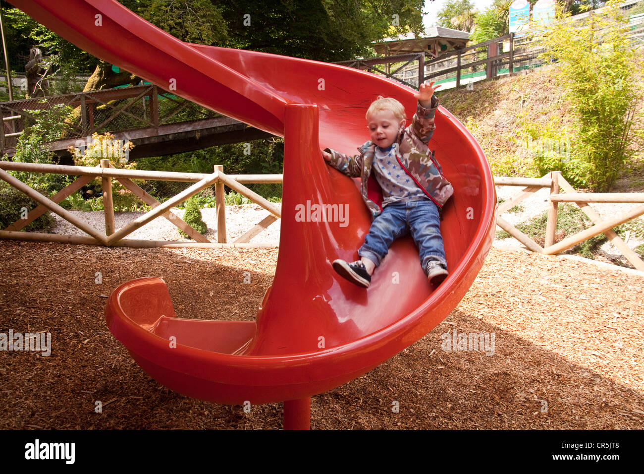 Red children's slide at Woodlands Family Theme Park, Totnes, Devon , England, United Kingdom. Stock Photo