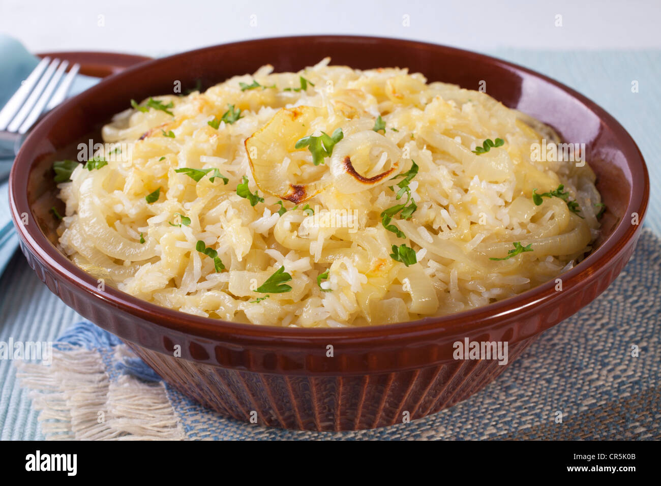 A delicious basmati rice casserole, with buttery onions and gruyere cheese Stock Photo