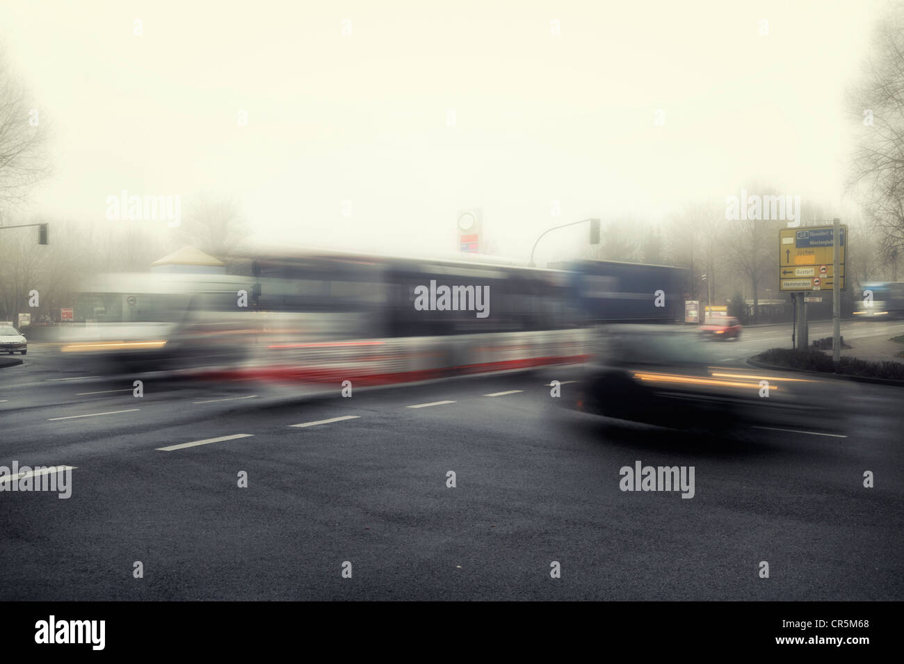 Morning traffic at an intersection in the early morning mist, motion blur Stock Photo