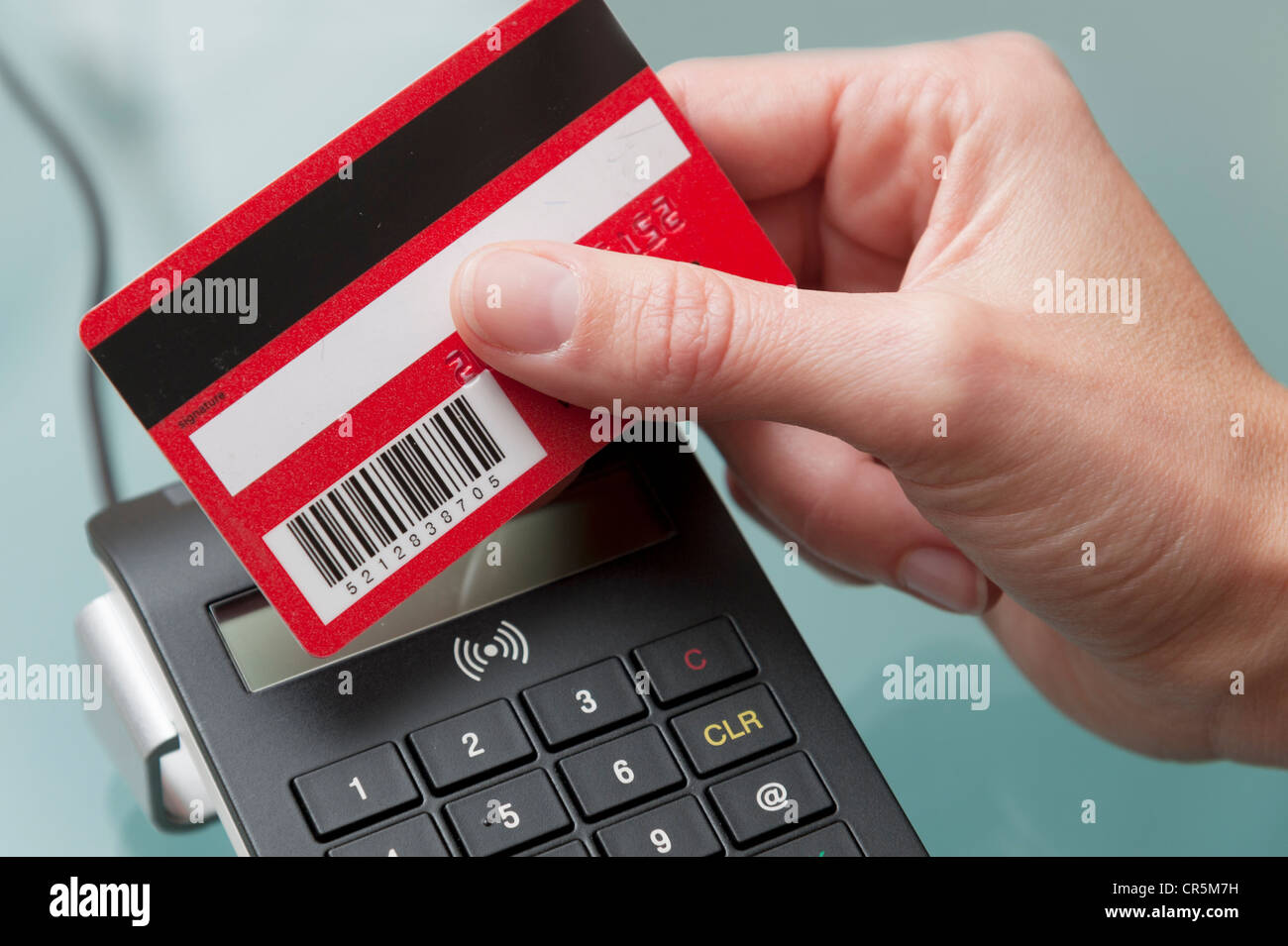 Hand holding an electronic card against a reader Stock Photo