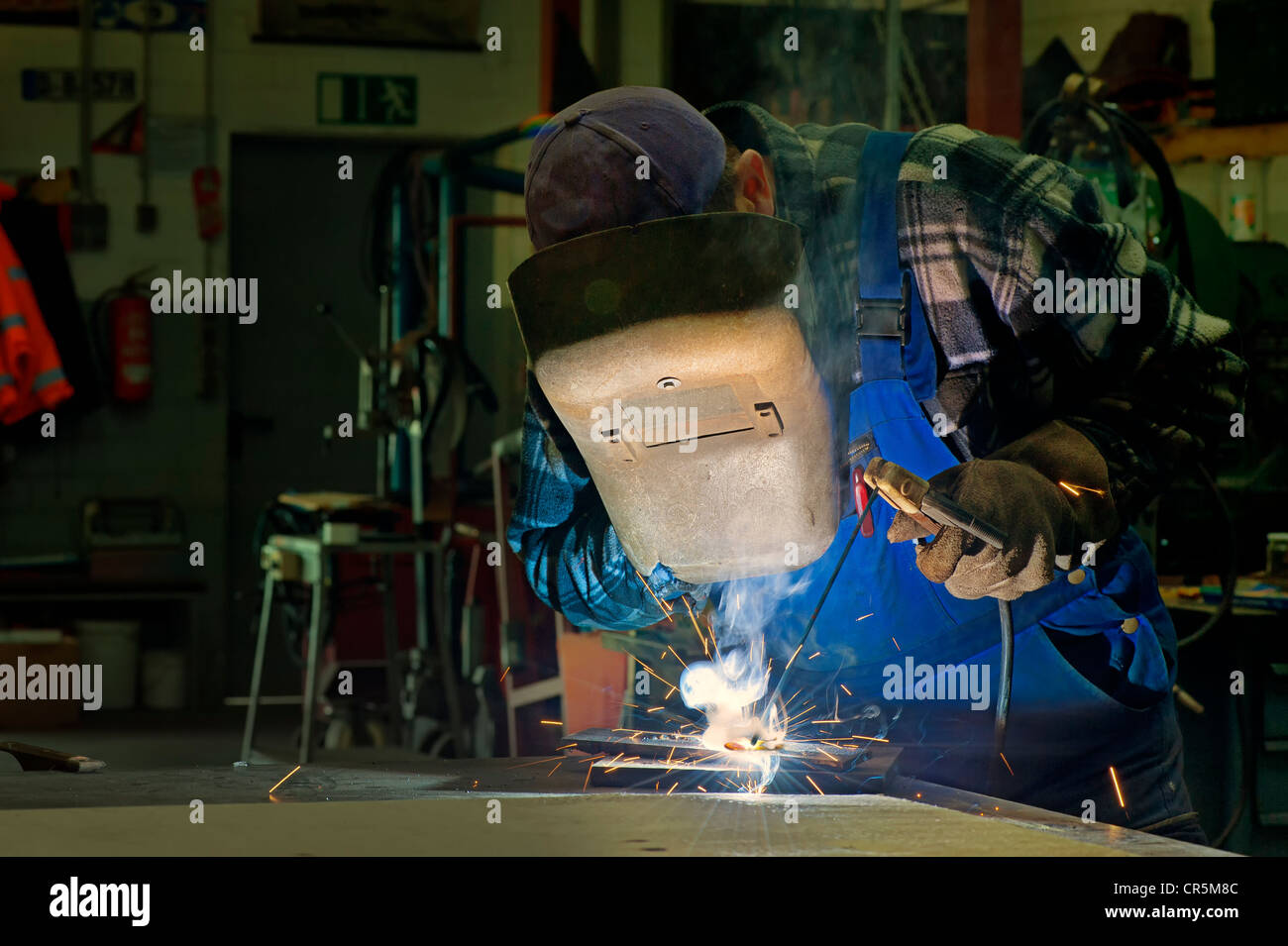Welder doing electric welding in his workshop Stock Photo