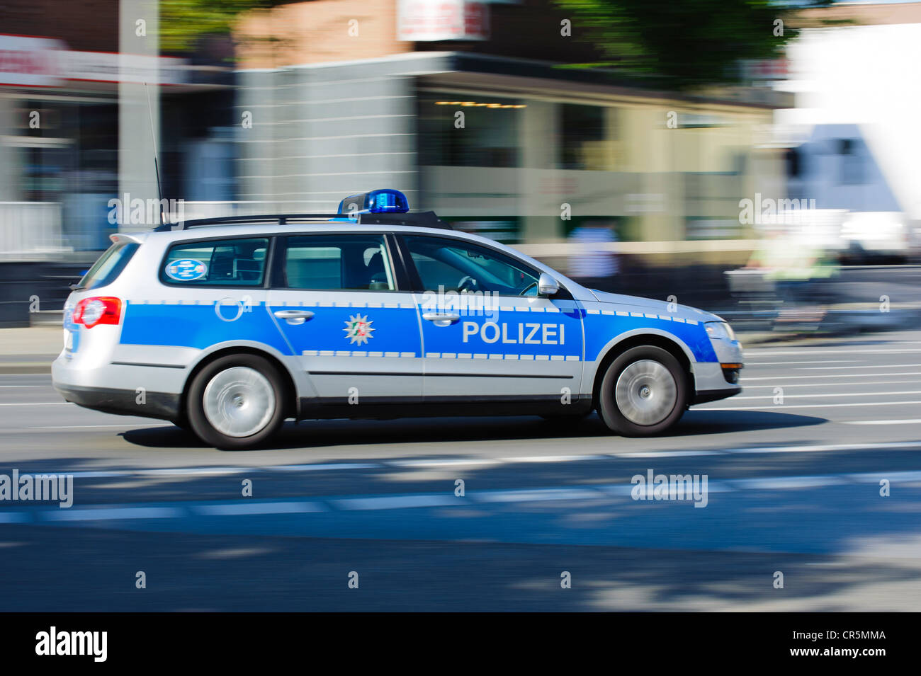 Police car on an emergency call driving at high speed Stock Photo