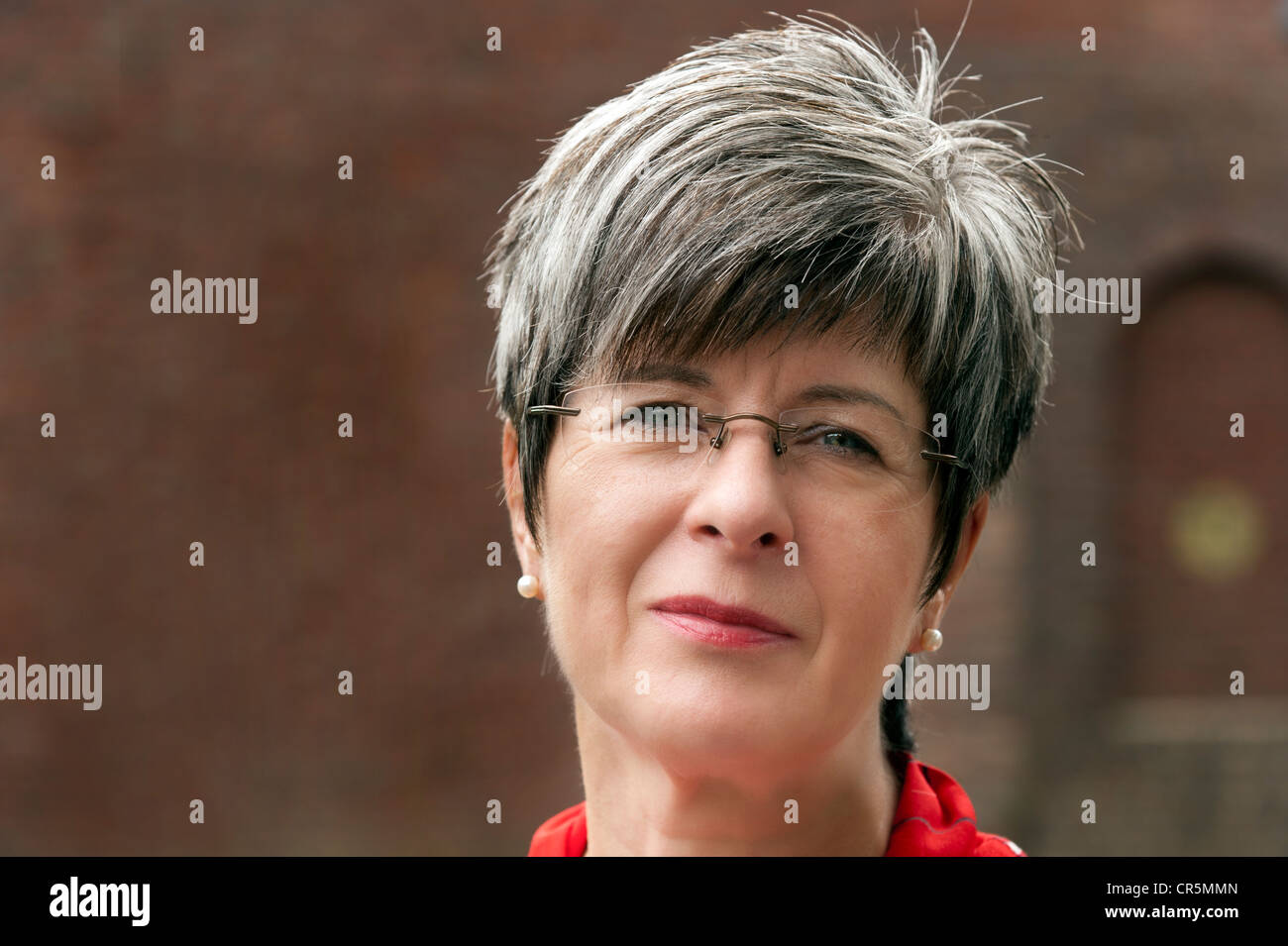 Woman, 50+, with short gray hair and glasses, portrait Stock Photo