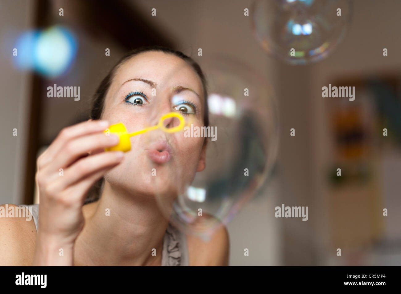 Young woman making soap bubbles Stock Photo Alamy