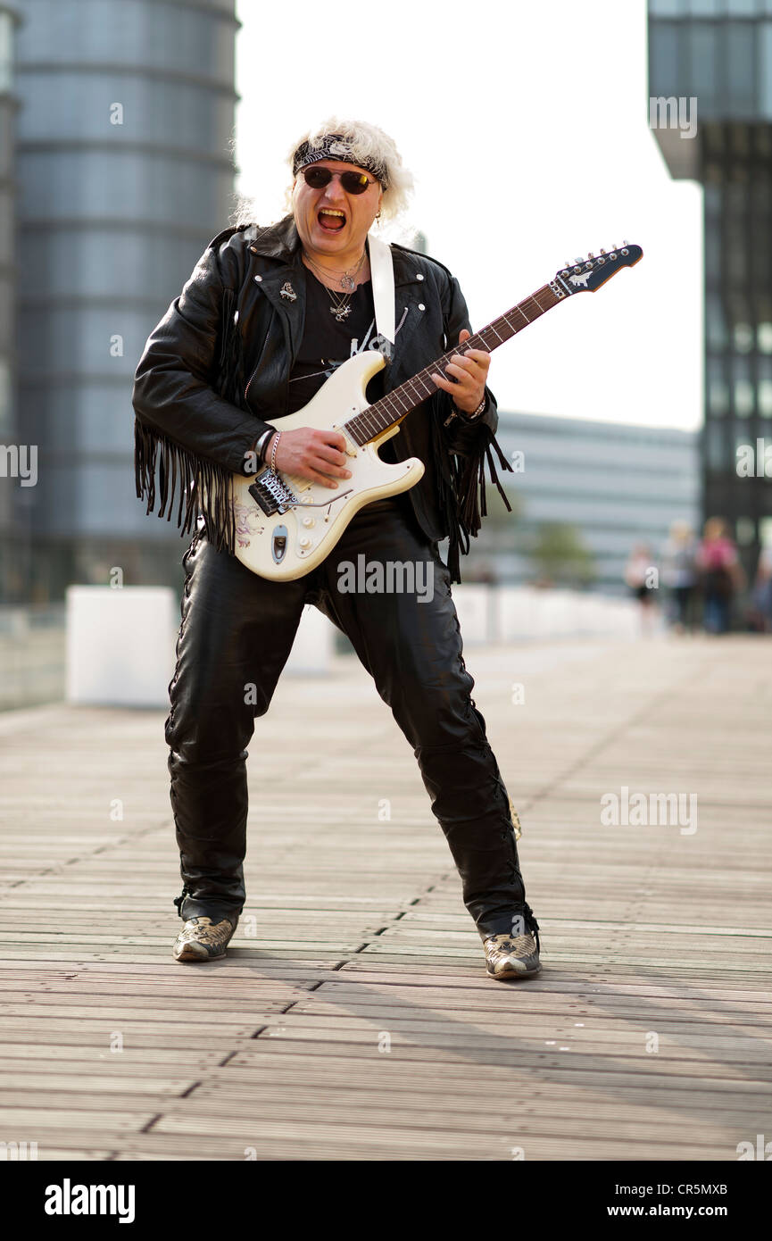 Hard rock musician in the Medienhafen Media Harbour, Duesseldorf, North Rhine-Westphalia, Germany, Europe Stock Photo