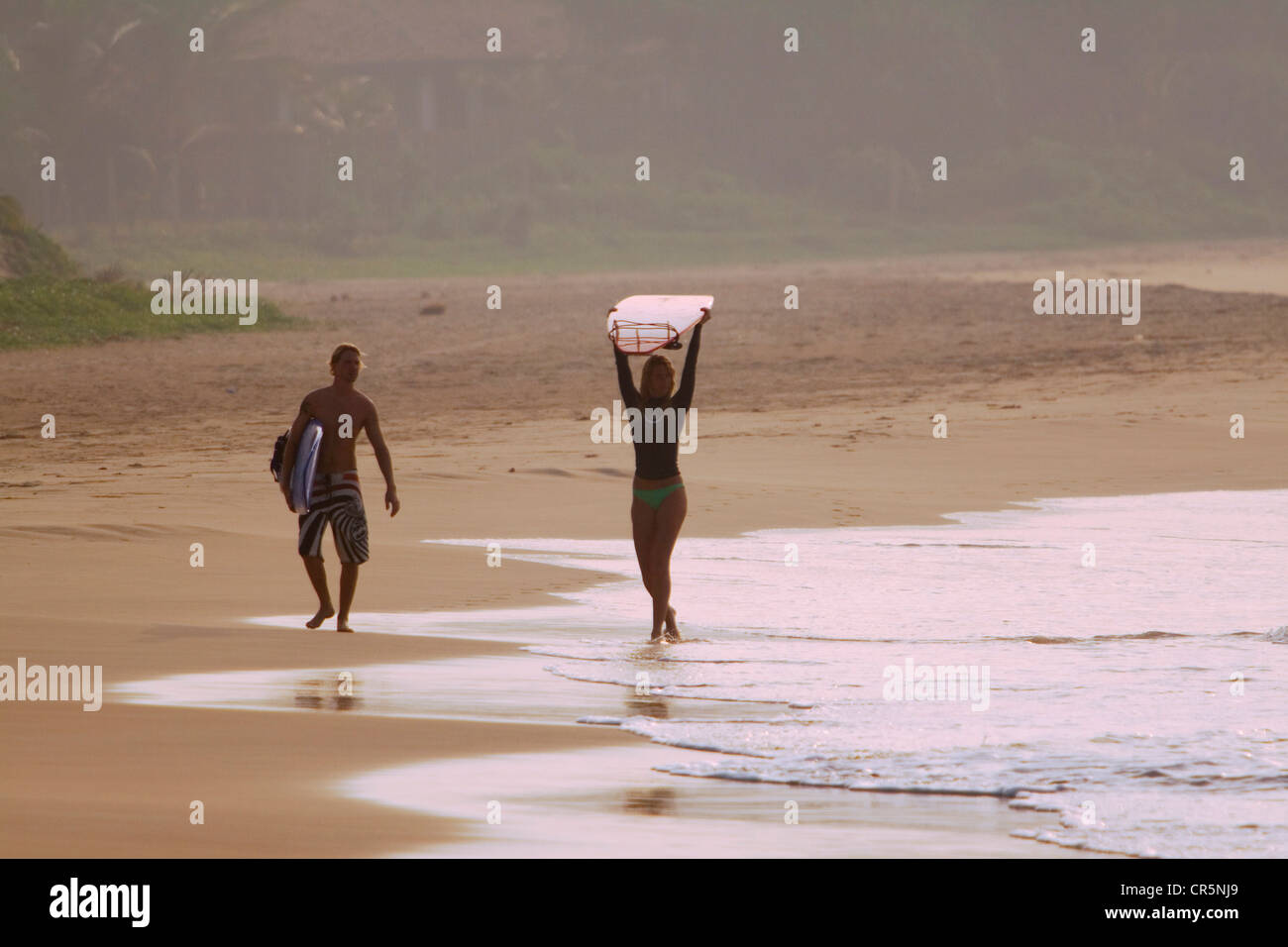 Surfers on the beach at the break known as Kabalana, Ahangama, Southern, Sri Lanka Stock Photo