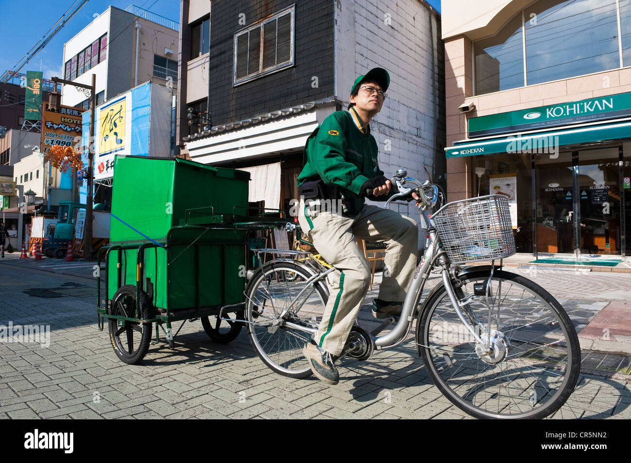 Japan, Honshu Island, Kinki Region, city of Nara, city center, the Sanjodori Street, bicycle messenger Stock Photo