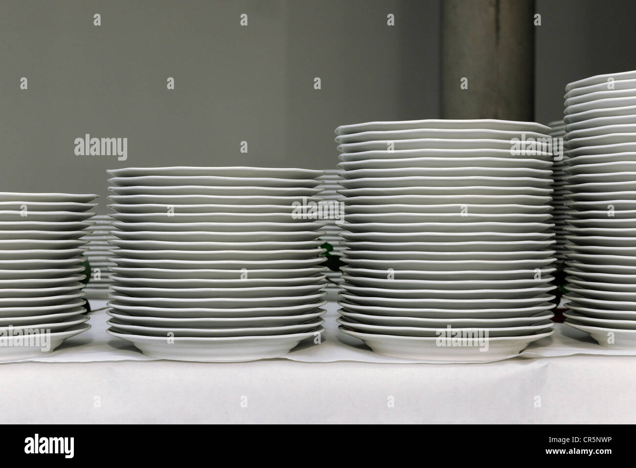 Stacks of white dinner plates on a table, preparations for a corporate event, Thuringia, Germany, Europe Stock Photo