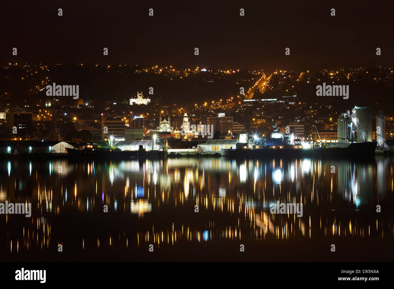 Otago Boys High School, St Pauls Cathedral, Municipal Chambers Clock Tower, and Stuart Street, reflected in harbour, Dunedin Stock Photo