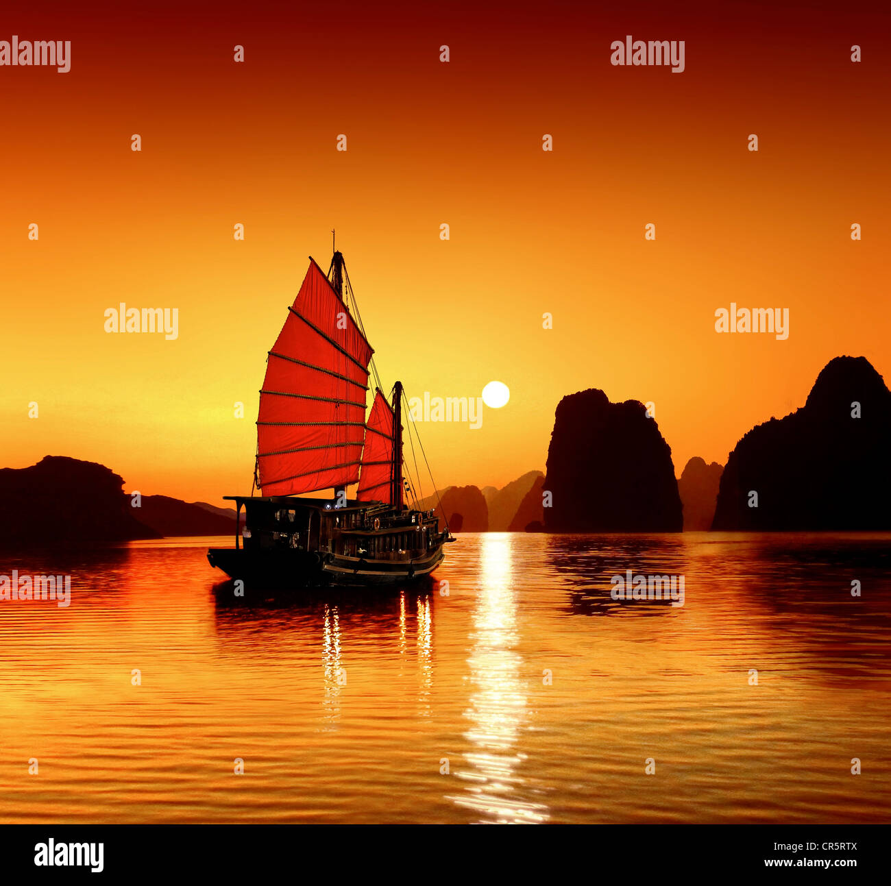 Junk in the sea of Halong Bay, a UNESCO World Natural Heritage Site, Karst mountains, romantic sunset, image composition Stock Photo