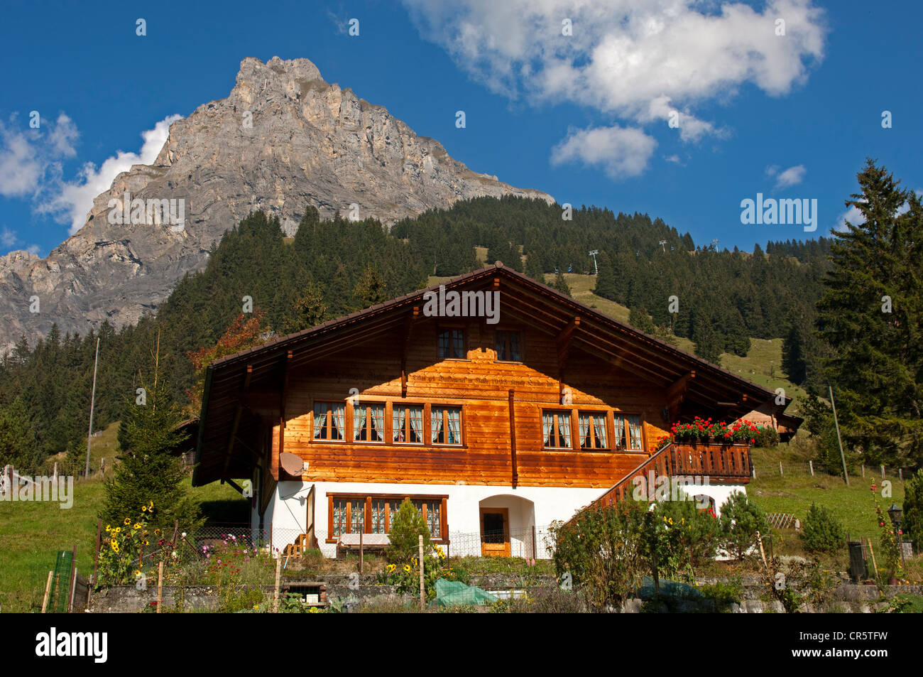 Modern home in the Swiss chalet-style at the foot of a mountain, Kandersteg, Bernese Oberland, Switzerland, Europe Stock Photo