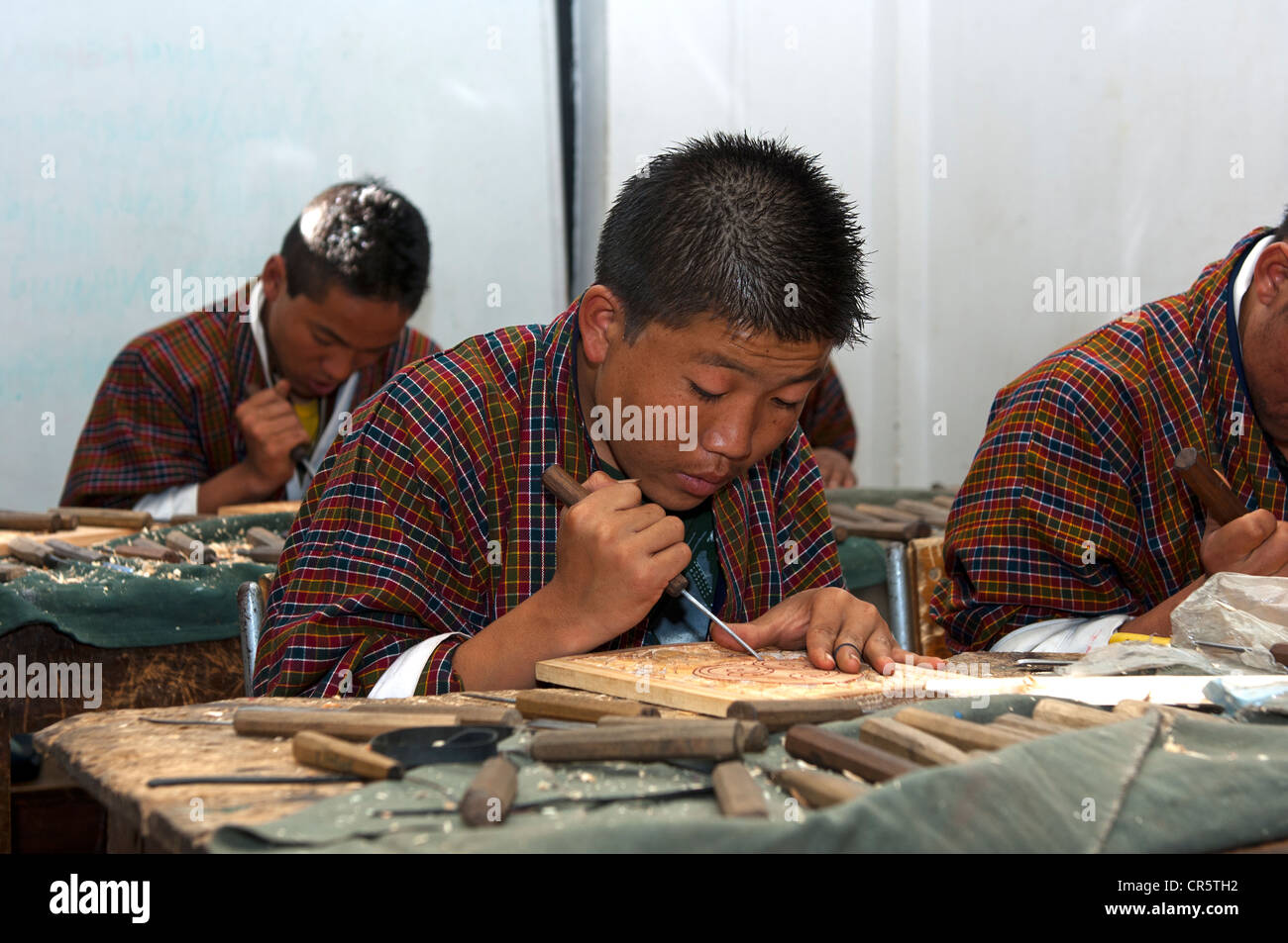 Highly concentrated students doing an apprenticeship in woodcarving at the National Institute of Traditional Arts and Crafts Stock Photo
