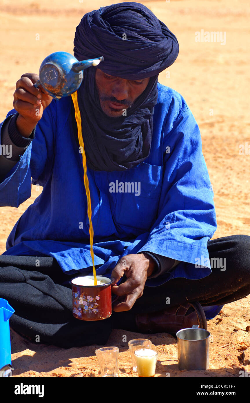 Arabic tea ceremony, Tuareg man preparing the traditional sweet mint
