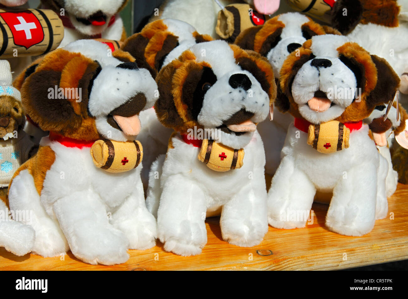 St. Bernard dog soft toys with barrel of rum at the neck, souvenir stand at the Great St. Bernard Pass, Valais, Switzerland Stock Photo