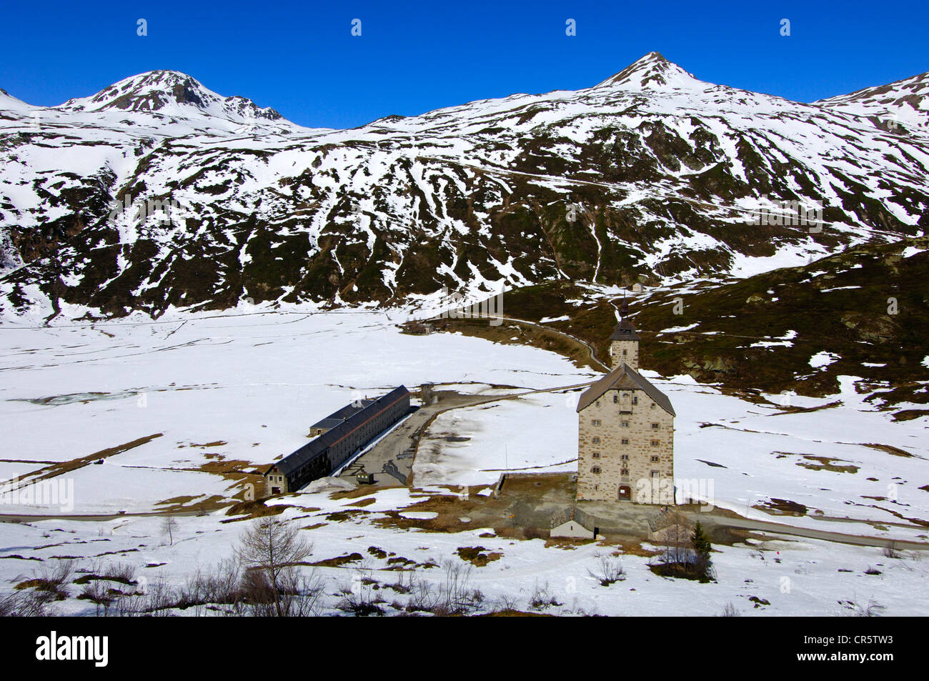 Medieval Alter Spittel hospital, built by Kaspar Jodok of Stockalper, surrounded by snow fields at the Simplon Pass in Stock Photo