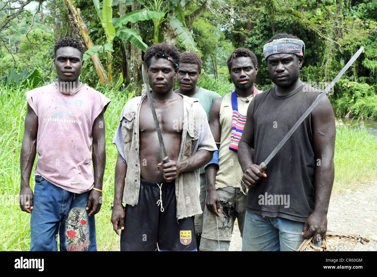 young men with clubs in the jungles of Bougainville Island, Papua New Guinea Stock Photo
