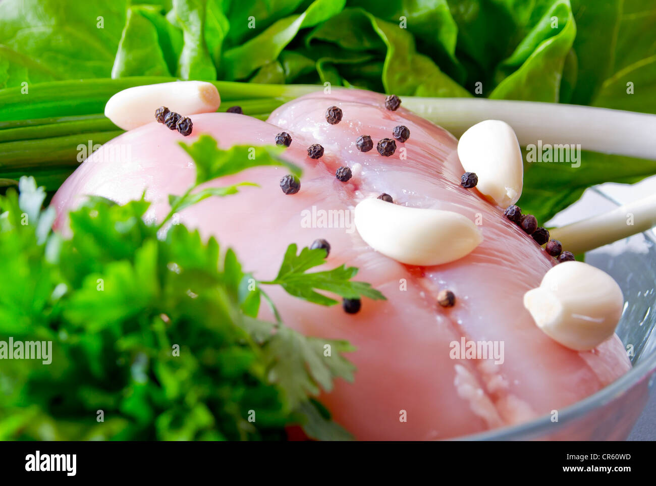 Whole raw chicken with vegetables and pepper Stock Photo