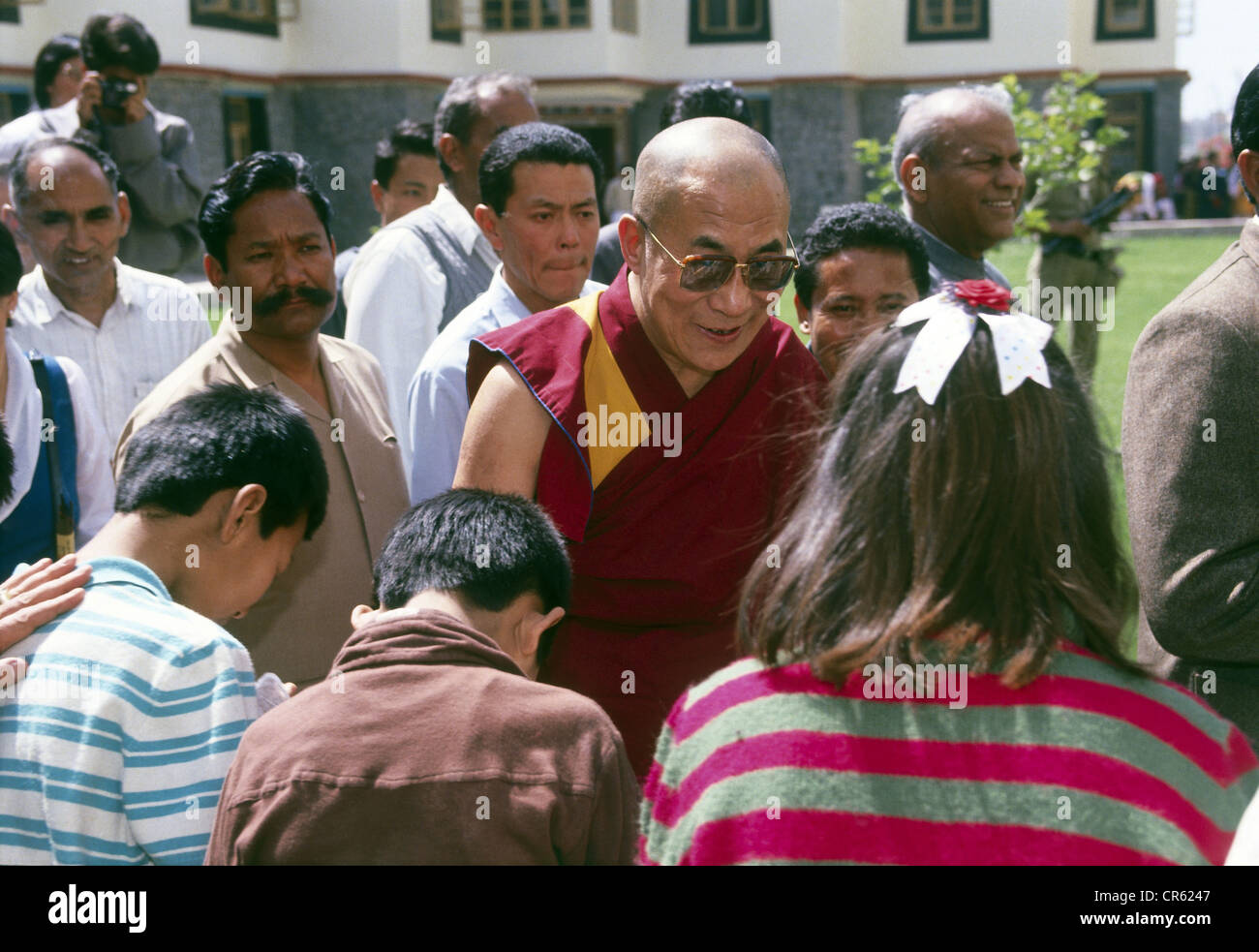 Dalai Lama 14th (Tenzin Gyatso), * 6.7.1935, Tibetan lama and politician, half length, with Tibetan children, SOS Children`s Villages, New Delhi, India, March 1991, Stock Photo