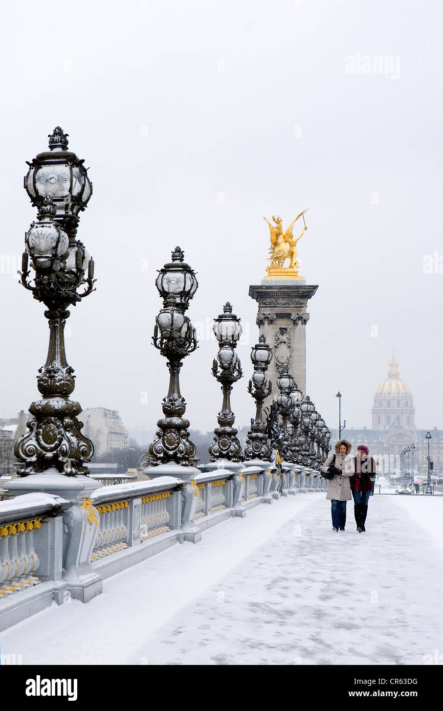 France, Paris, the Pont Alexandre III under the snow with the dome of the Invalides in the background Stock Photo
