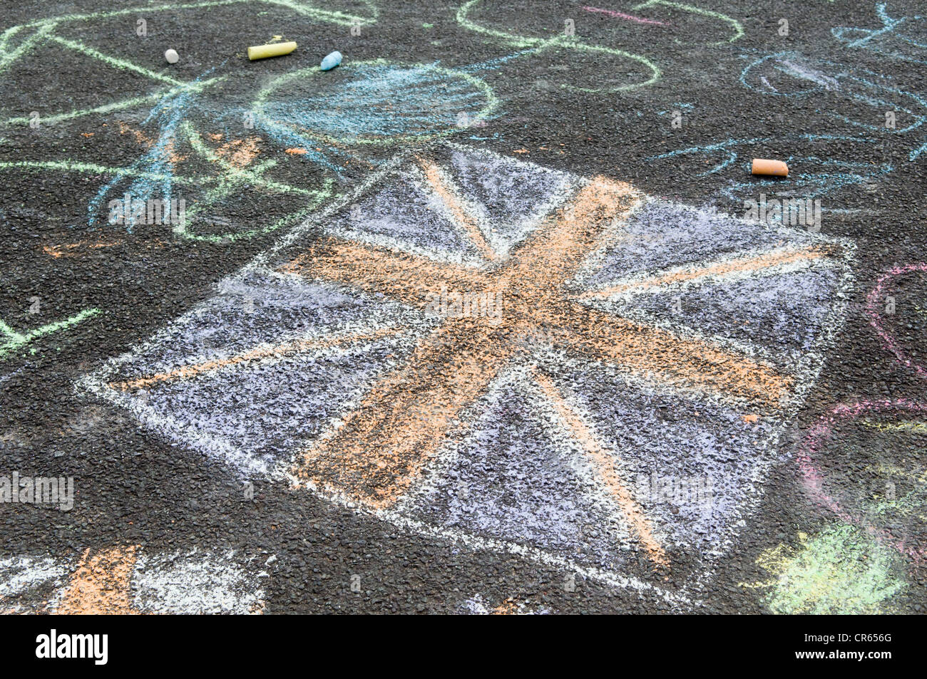 Graffiti chalk drawings of union jack flag on tarmac road in Bristol