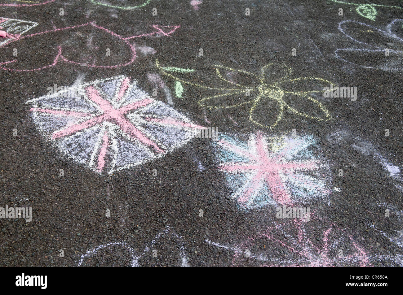 Graffiti chalk drawings of union jack flag on tarmac road in Bristol