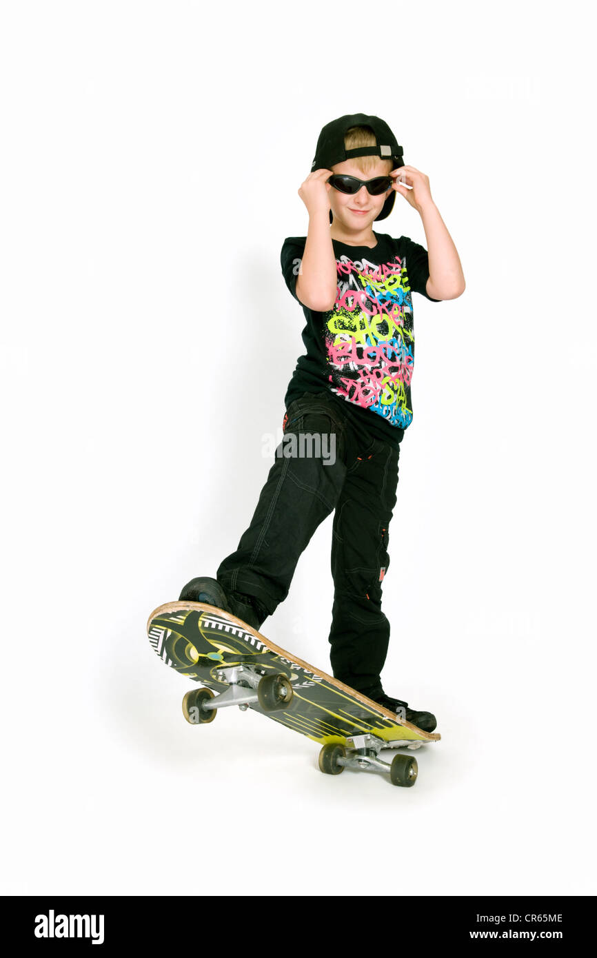 Studio image of Caucasian 8 year old boy with skateboard on a white background Stock Photo
