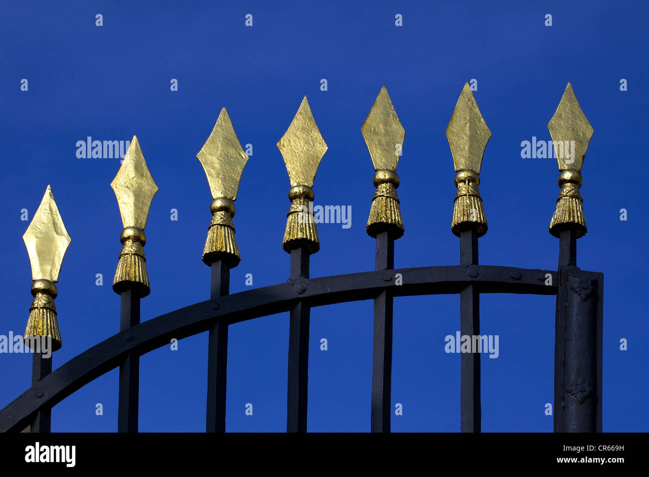 Fence bars with gold-colored heads Stock Photo