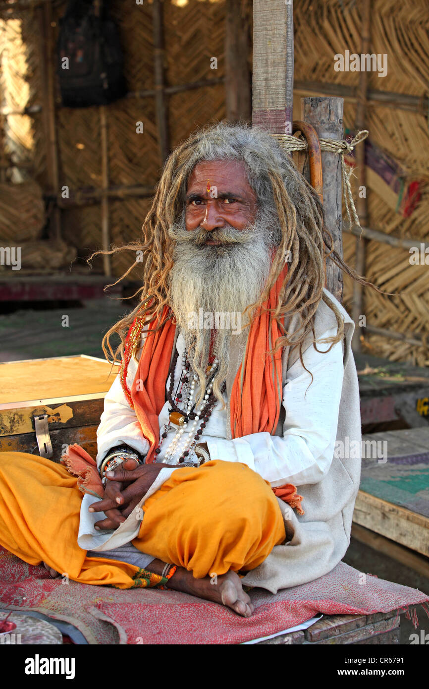 Sadhu, an Indian wandering holy man, sitting alongside the Ganges River, Garhmukteshwar, Uttar Pradesh, North India, India, Asia Stock Photo
