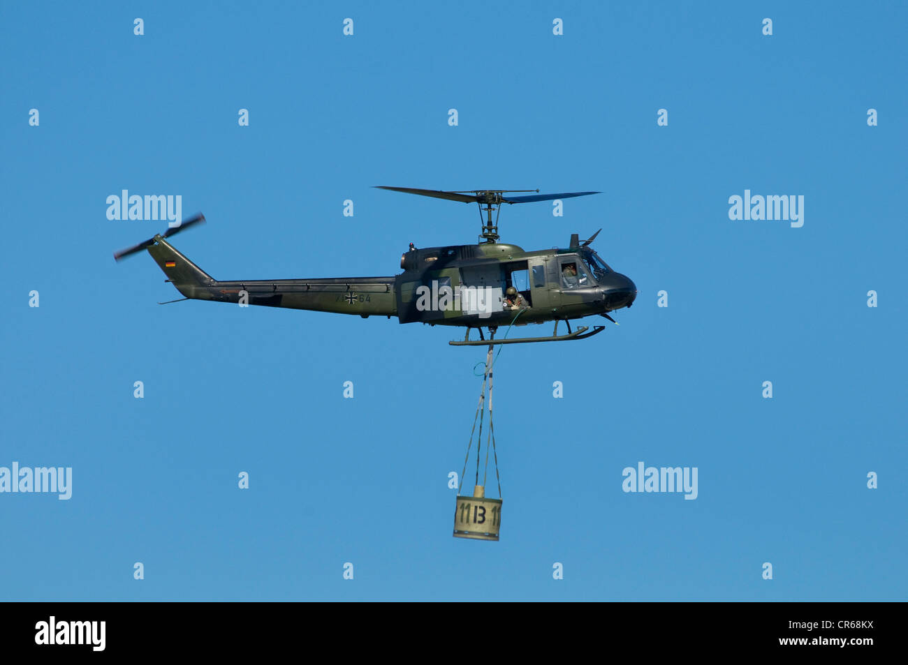 Bundeswehr army helicopter with a helicopter bucket to fight fires