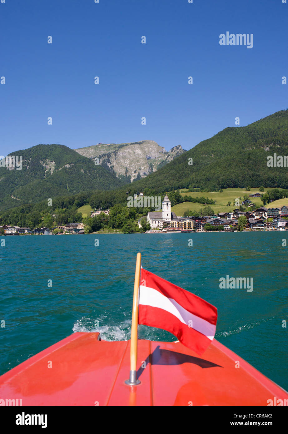 Austria, Boat with flag in Wolfgangsee Lake Stock Photo