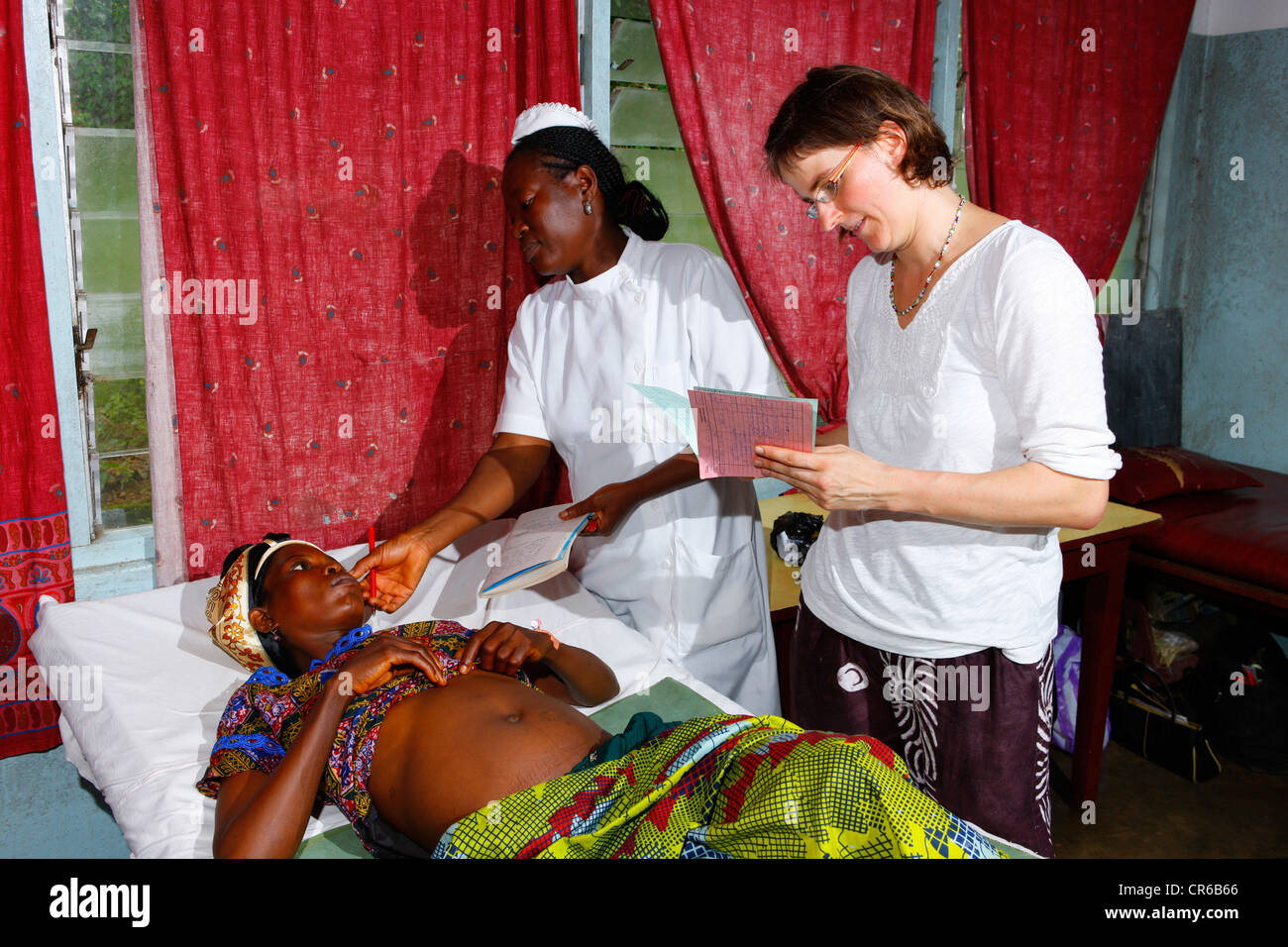 Midwife and doctor examining a pregnant woman, hospital, Manyemen, Cameroon, Africa Stock Photo