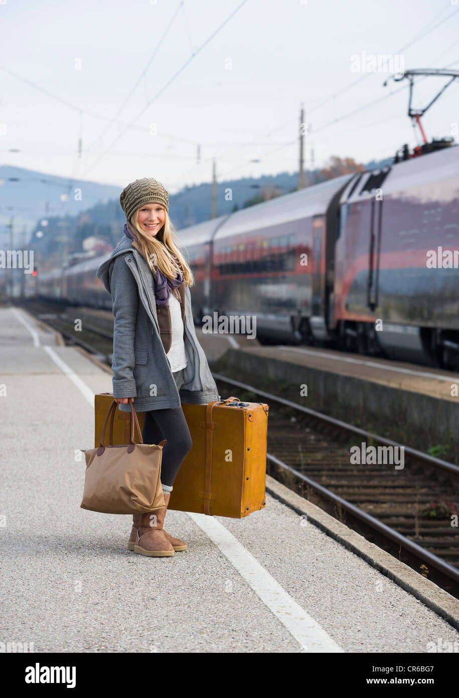 Austria, Teenage girl with suitcase on train station Stock Photo Alamy