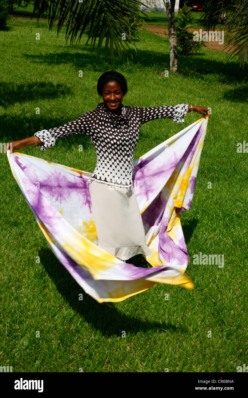 Woman dancing with batik fabric, Kumba, Cameroon, Africa Stock Photo