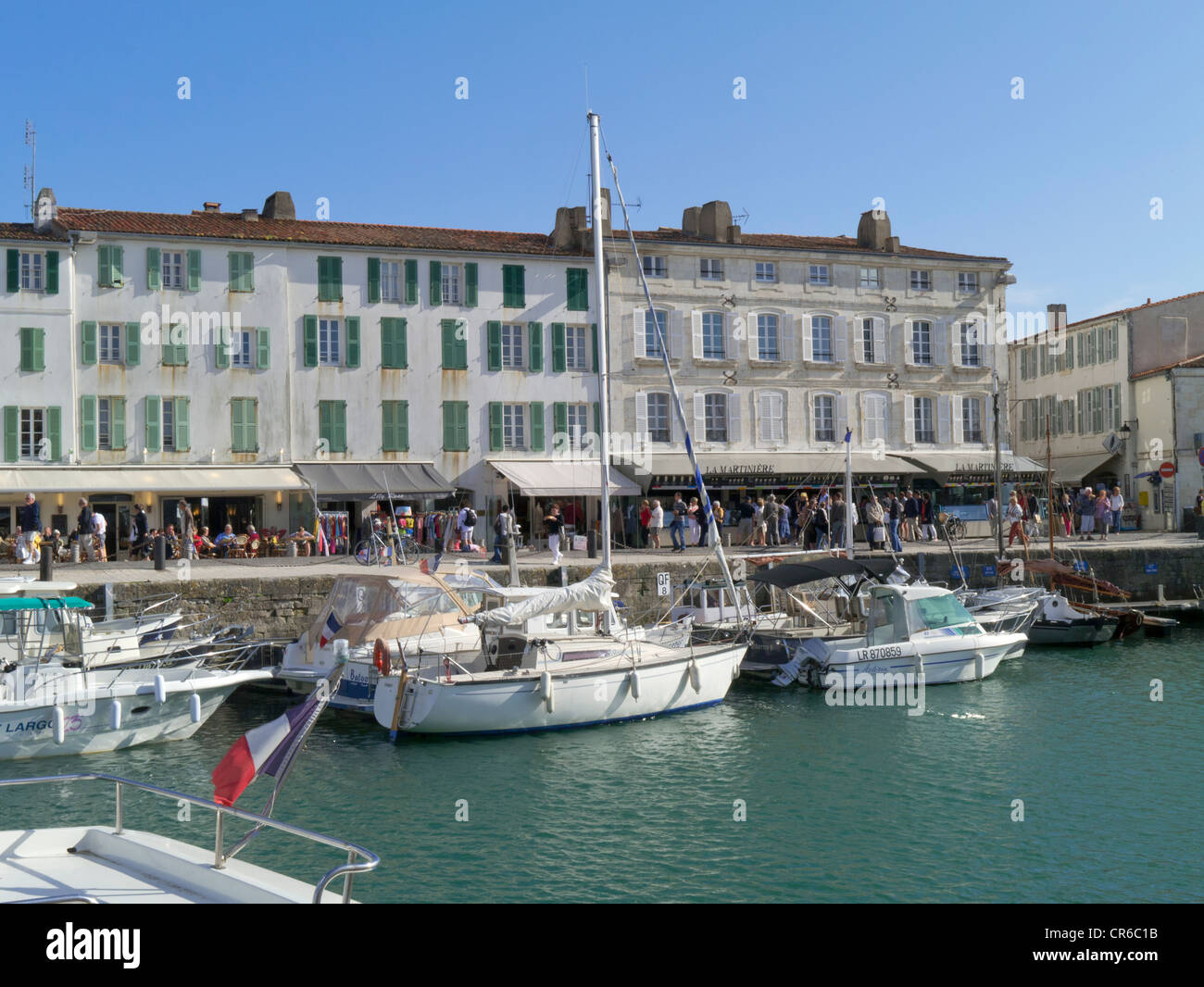 France, Ile de Re, St Martin de Re, harbour towards town and restaurants with boats in foreground Stock Photo