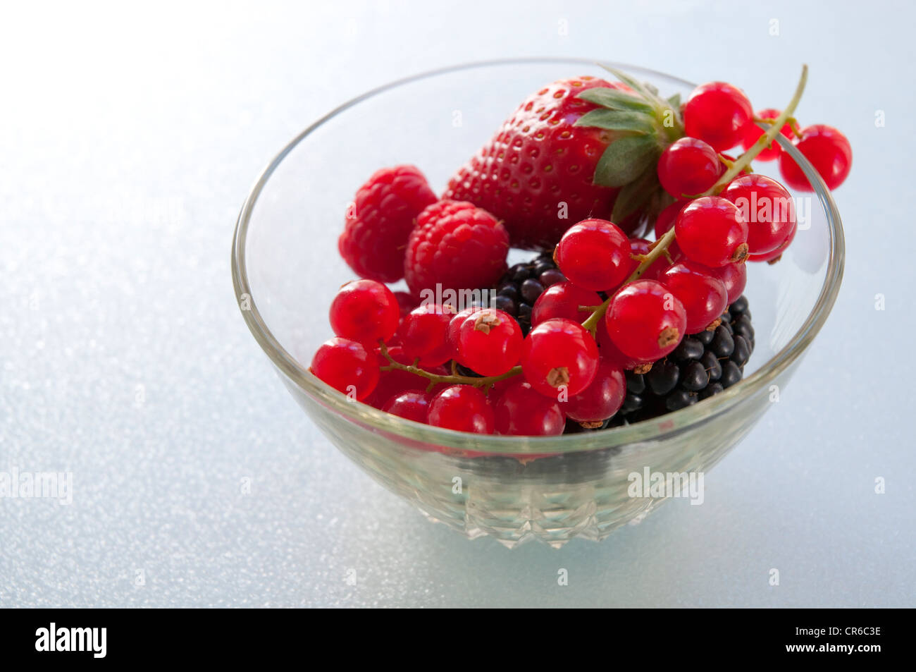 Red fruits in a fruit bowl. Close view. Stock Photo