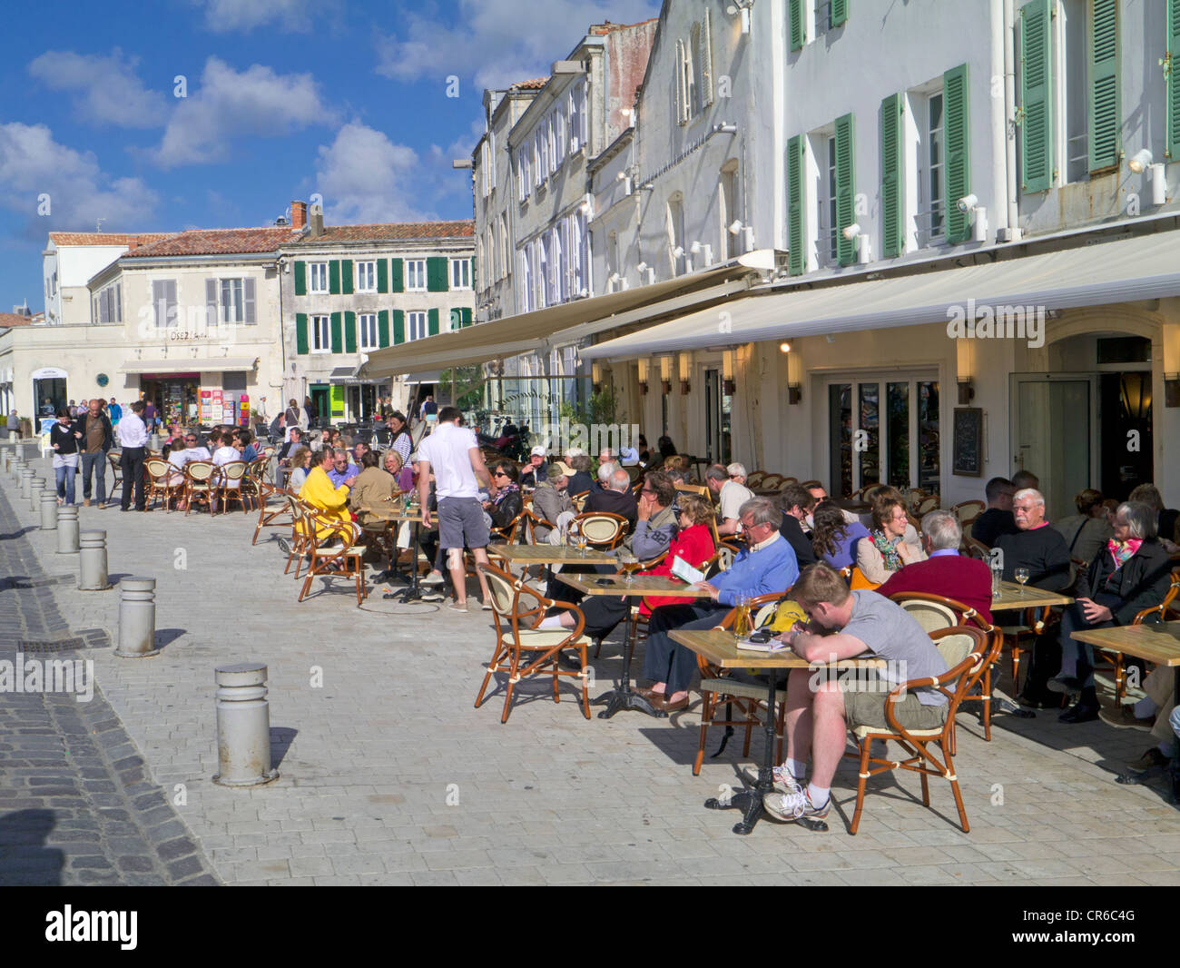 France, Ile de Re, St Martin de Re, harbour , people sitting at cafes and restaurants Stock Photo