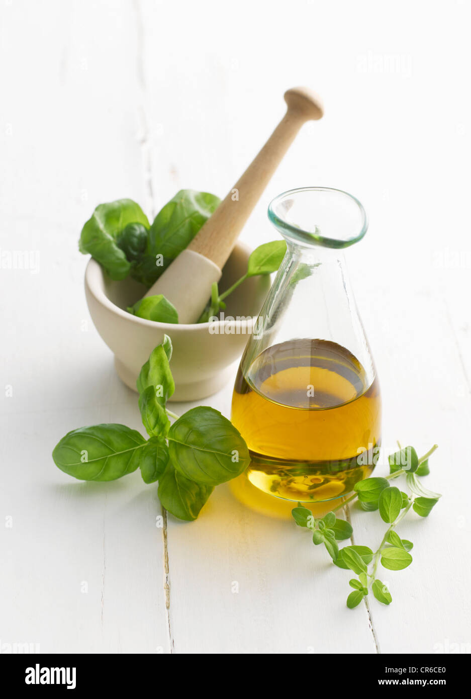 Basil and oregano leaf in mortar and pestle Stock Photo