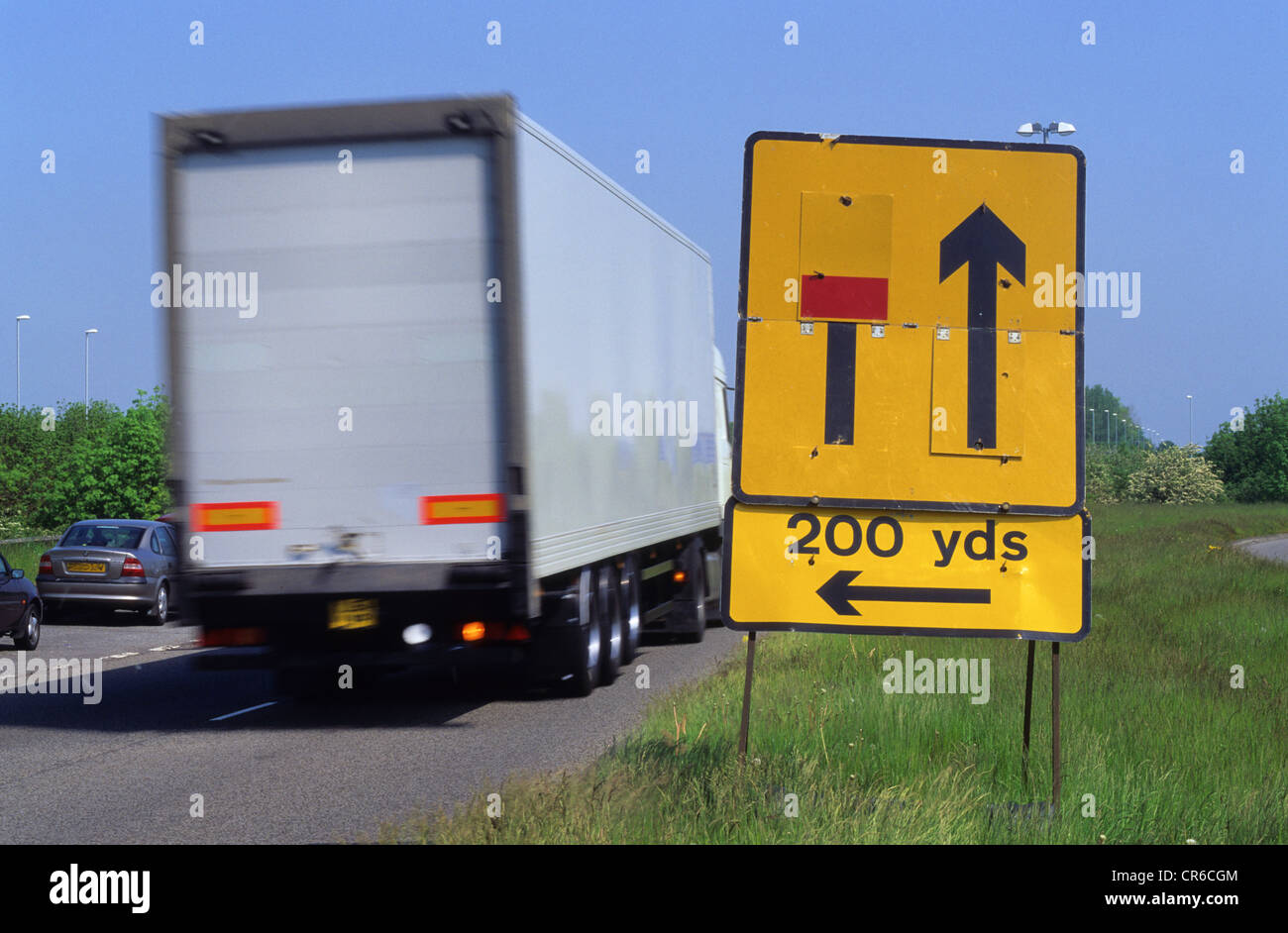 lorry passing warning sign of closed left hand lane ahead on dual