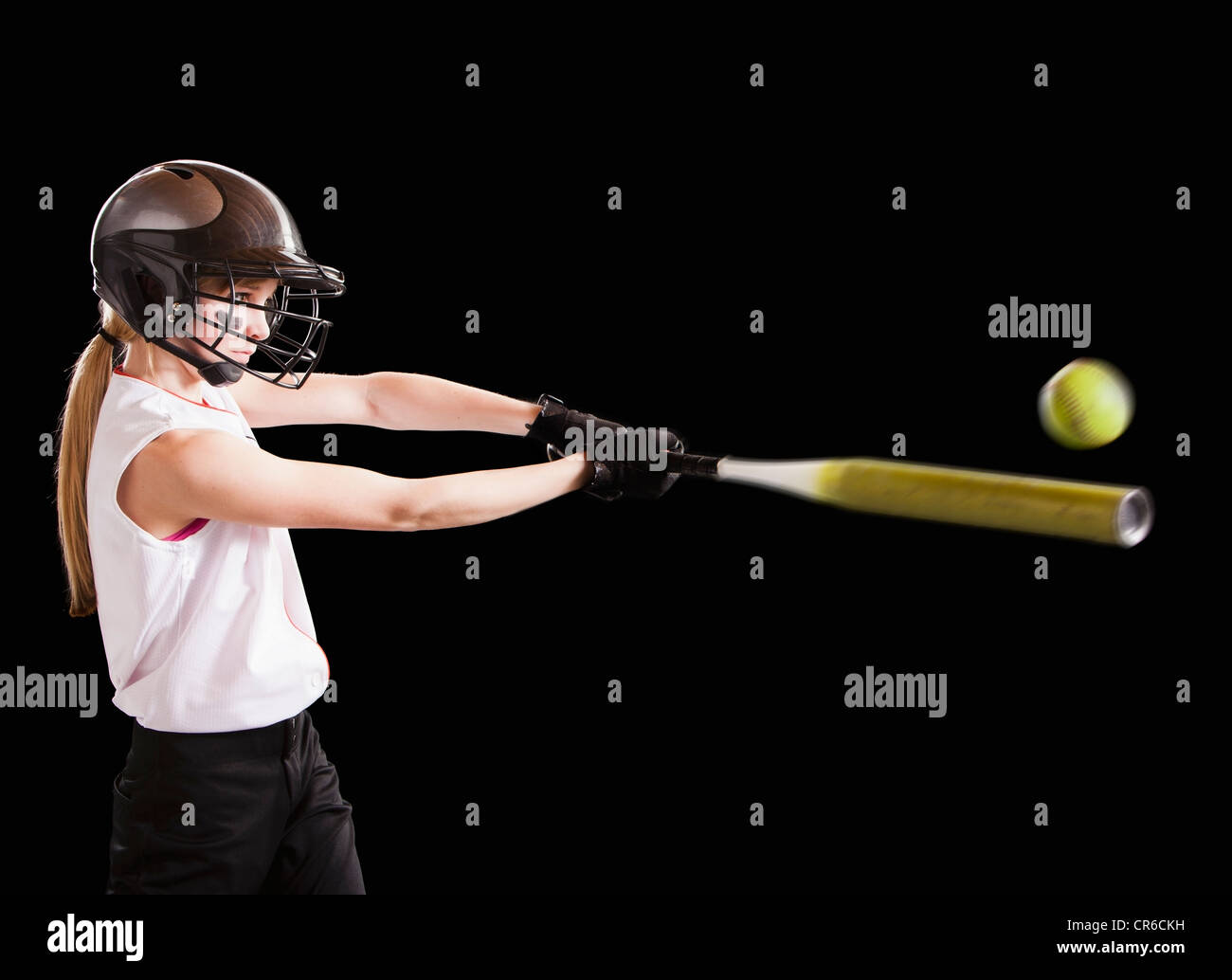 Girl (12-13) plying softball, studio shot Stock Photo