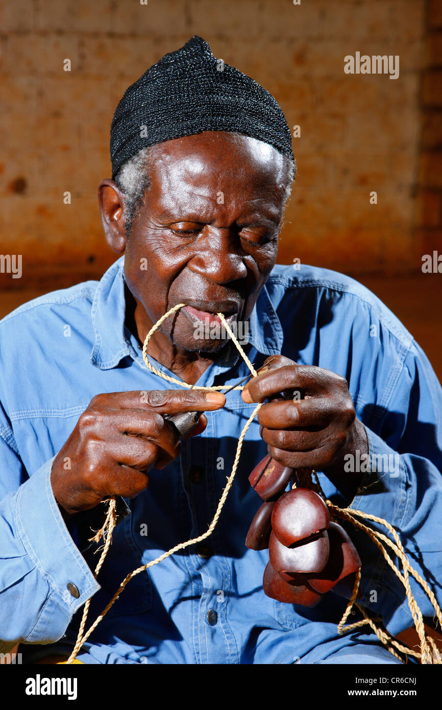 Man making traditional foot and hand rattles, Juju Rattles from Uyot ...