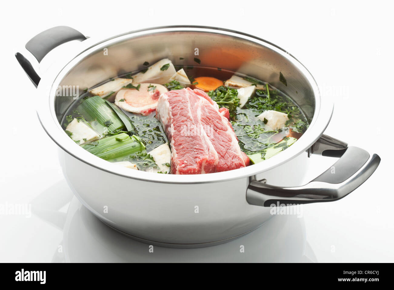 Beef broth ingredient in stew pot on white background Stock Photo Alamy