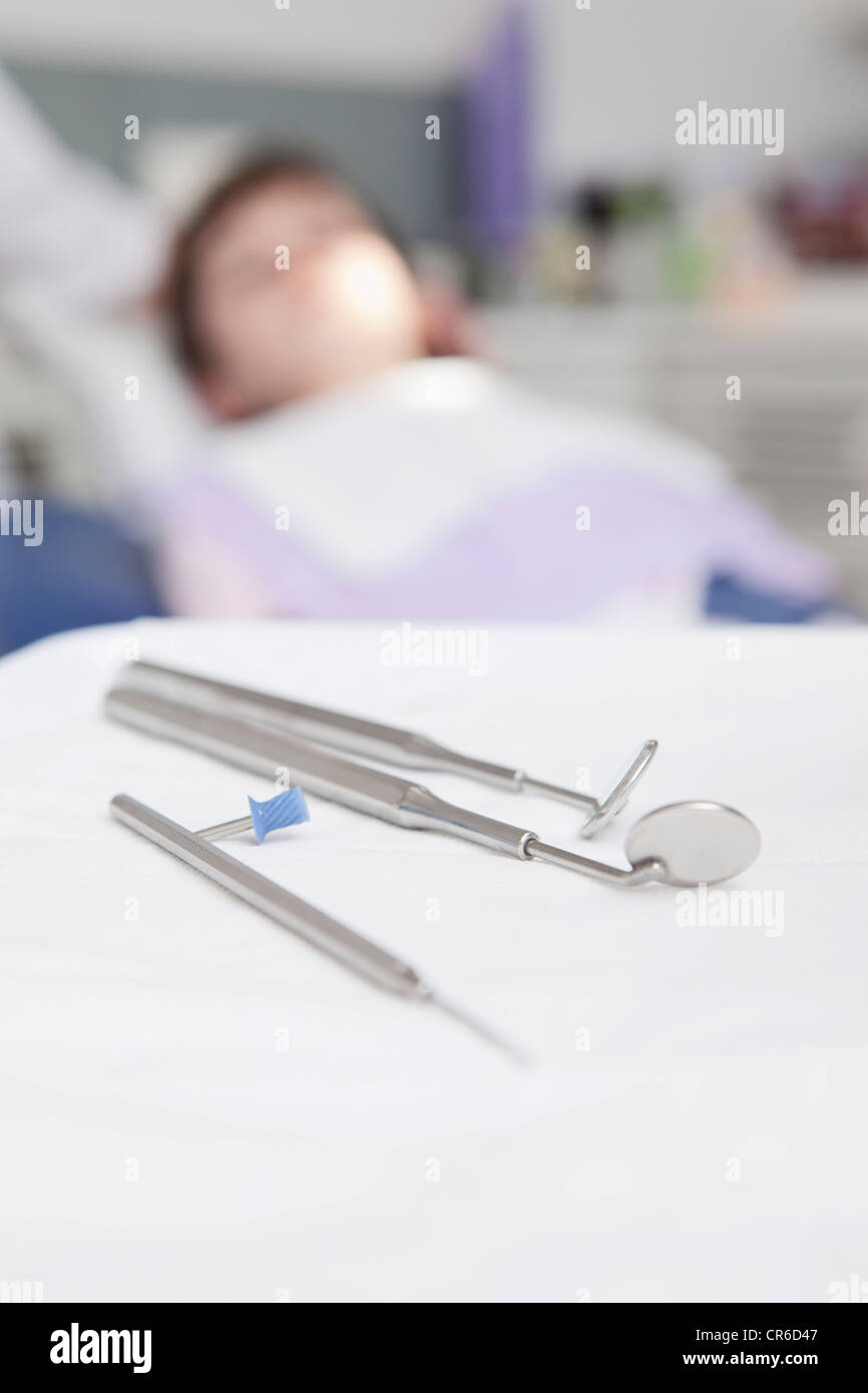 Germany, Bavaria, Dental instrument with patient in background Stock Photo