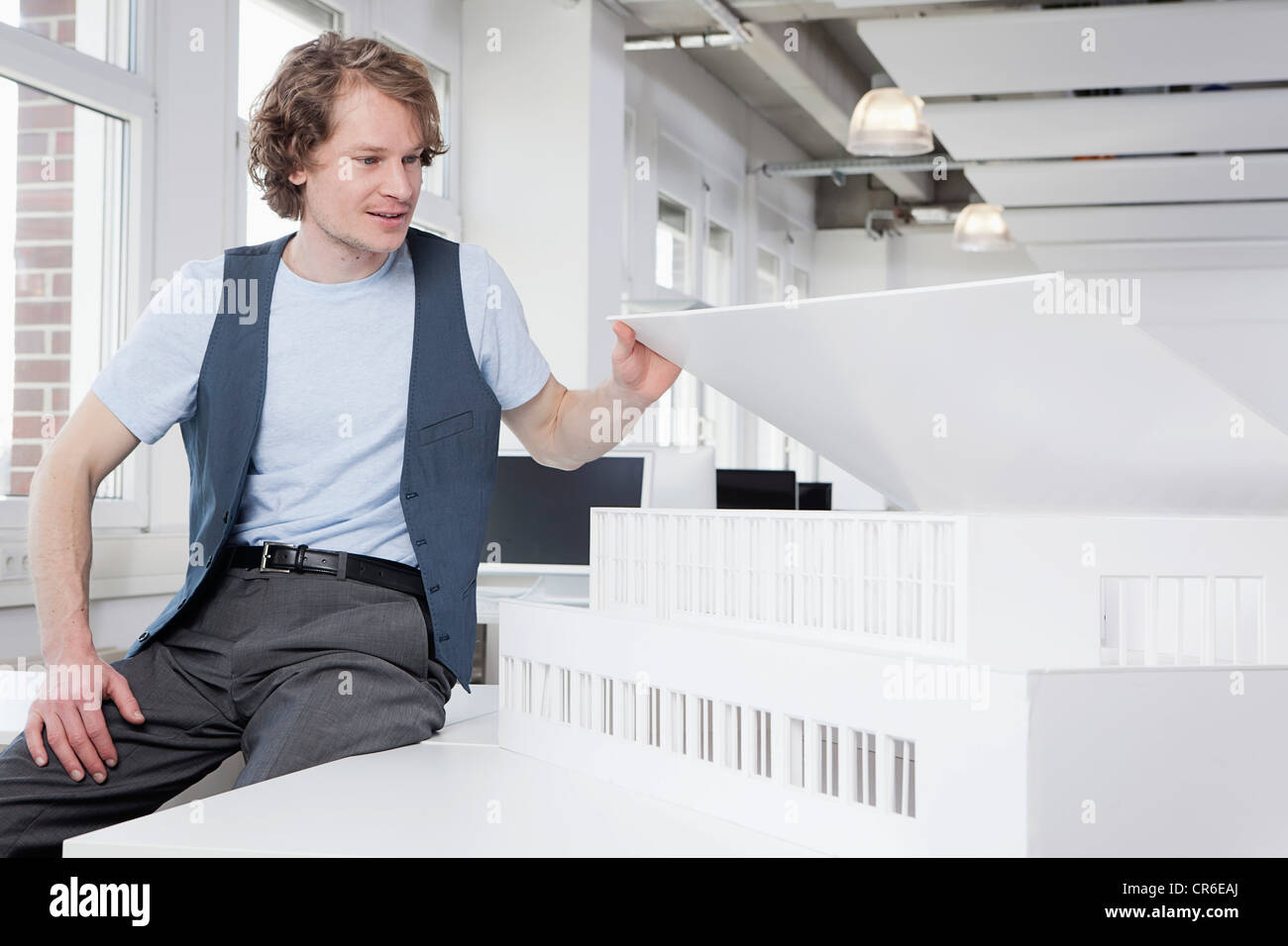 Germany, Bavaria, Munich, Architect looking at architectural model Stock Photo