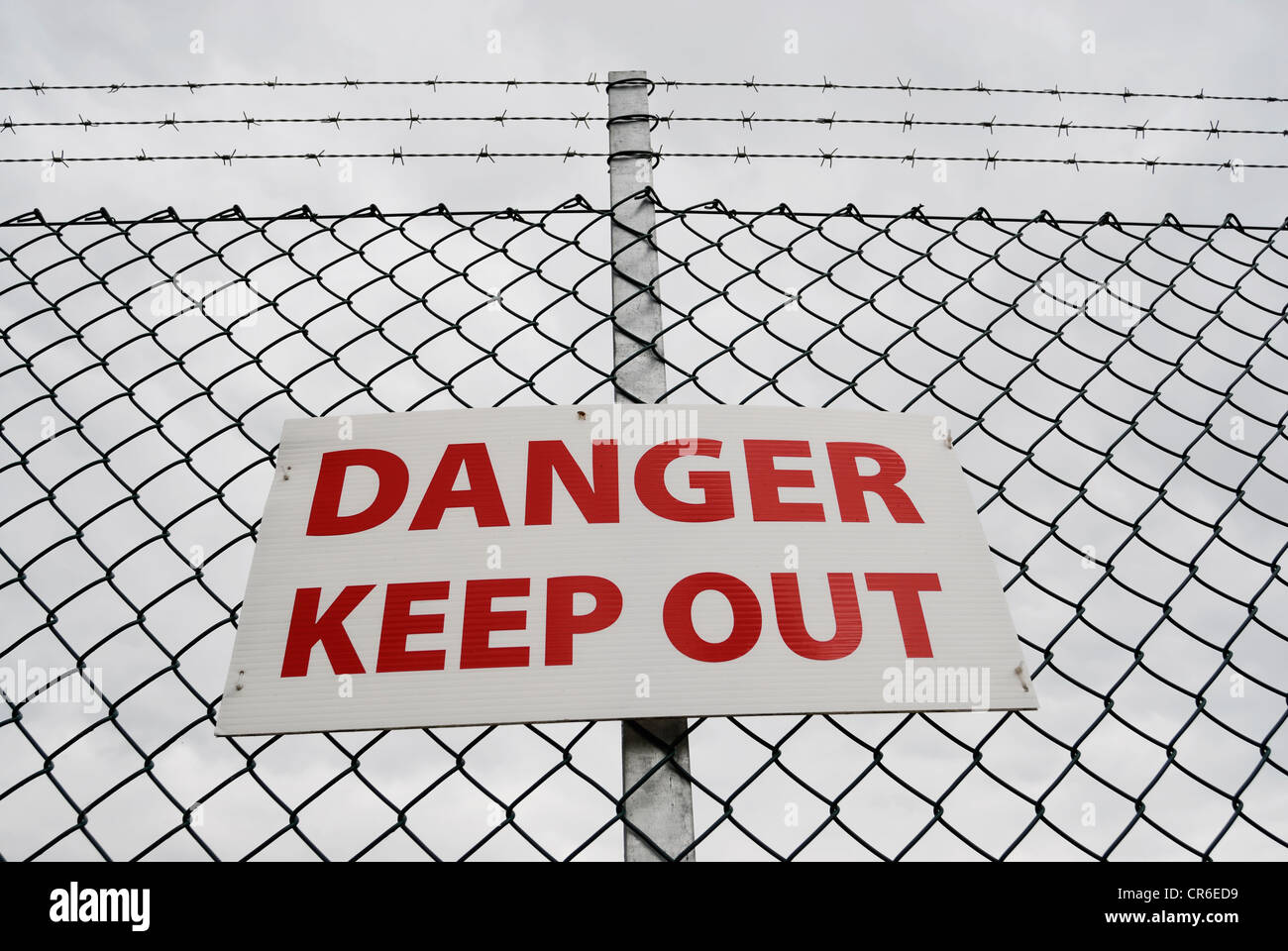 Danger Keep Out sign on a chain link fence topped with barbed wire Stock  Photo - Alamy
