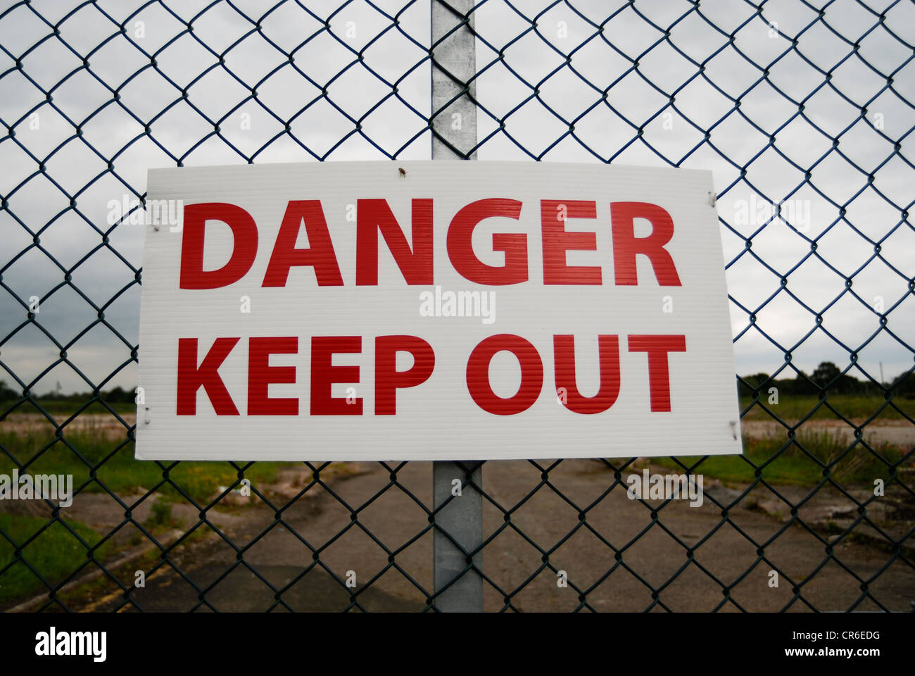 Danger Keep Out sign on a chain link fence topped with barbed wire Stock  Photo - Alamy
